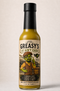 Bottle of Greasy's hot sauce with a label featuring a cartoon character on a beige background